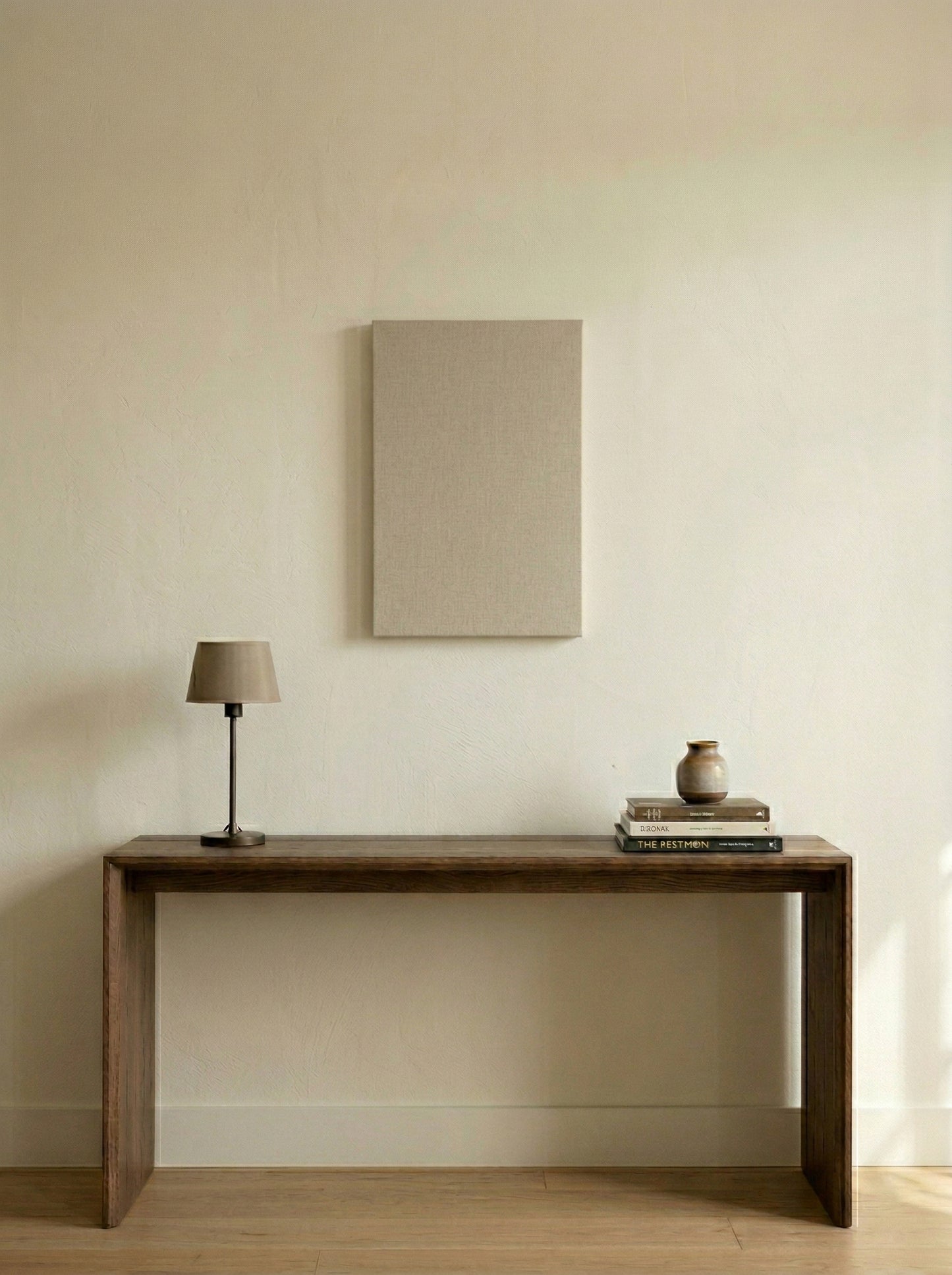 Minimalist interior with a wooden console table against a plain wall.